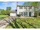 Charming home featuring a well-manicured lawn, black shutters and a paved driveway leading to an attached garage at 8719 Sweet Sage Ln, Charlotte, NC 28227