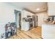An eat-in kitchen featuring stainless steel appliances, white cabinets, and a breakfast area with wood flooring at 8719 Sweet Sage Ln, Charlotte, NC 28227