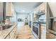 A well-equipped kitchen featuring stainless steel appliances, granite counters, white cabinets and a window at 8719 Sweet Sage Ln, Charlotte, NC 28227
