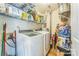 Functional laundry area with washer, dryer, and plenty of storage on wire shelving at 8719 Sweet Sage Ln, Charlotte, NC 28227
