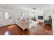 A formal living room featuring hardwood floors, fireplace and lots of natural light at 8719 Sweet Sage Ln, Charlotte, NC 28227