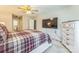 Spacious main bedroom with a large bed, wall-mounted TV, and ample closet space, providing a relaxing environment at 8719 Sweet Sage Ln, Charlotte, NC 28227