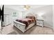 Serene main bedroom featuring a large bed with decorative headboard and bench, offering a comfortable retreat at 8719 Sweet Sage Ln, Charlotte, NC 28227