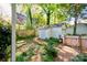 A backyard with a small storage shed and a wooden fence and a brick walkway at 902 Hawthorne Rd, Shelby, NC 28150