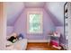 A cozy room featuring a slanted ceiling, a window, and hardwood floors at 902 Hawthorne Rd, Shelby, NC 28150