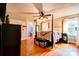 Bedroom with a four-poster bed, ceiling fan, hardwood floors and natural light from the windows at 902 Hawthorne Rd, Shelby, NC 28150