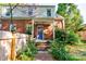 A charming brick home with a blue door framed by lush landscaping and a inviting walkway at 902 Hawthorne Rd, Shelby, NC 28150