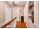 The hallway features hardwood floors, a wooden banister, and storage shelves at 902 Hawthorne Rd, Shelby, NC 28150