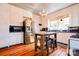 Bright kitchen boasts stainless appliances, tiled backsplash, wooden floors, and a chandelier at 902 Hawthorne Rd, Shelby, NC 28150