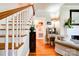 A foyer boasts wood floors and a staircase with white banisters and wooden handrail, leading to the upper level of the home at 902 Hawthorne Rd, Shelby, NC 28150