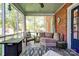 Cozy sunroom with brick wall, comfortable seating, and screened windows at 902 Hawthorne Rd, Shelby, NC 28150