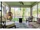 Relaxing sunroom with comfortable seating, neutral decor, and outdoor views at 902 Hawthorne Rd, Shelby, NC 28150
