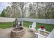 Backyard featuring a playhouse, a fire pit, an Adirondack chair set, and a white fence at 908 Carole Summey Dr, Dallas, NC 28034