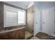Updated bathroom features a tiled shower, glass door, and neutral color scheme at 908 Carole Summey Dr, Dallas, NC 28034