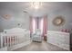 Cozy Bedroom with a white crib, a chair, a dresser, and pink accents at 908 Carole Summey Dr, Dallas, NC 28034