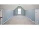 Bright empty room under an angled ceiling, perfect for customization, with a window and a door at 908 Carole Summey Dr, Dallas, NC 28034