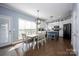 Spacious dining area connected to the kitchen featuring a lovely chandelier and natural light at 908 Carole Summey Dr, Dallas, NC 28034