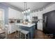 Well-appointed kitchen features a central island, white cabinets, and stainless steel appliances at 908 Carole Summey Dr, Dallas, NC 28034