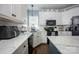 Bright kitchen with white cabinets, stainless steel appliances, and a herringbone backsplash at 908 Carole Summey Dr, Dallas, NC 28034