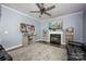 Bright living room with fireplace, ceiling fan, wood floors and stylish decor at 908 Carole Summey Dr, Dallas, NC 28034