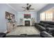 Cozy living room features a fireplace, ceiling fan, and comfortable seating with a blue accent rug at 908 Carole Summey Dr, Dallas, NC 28034