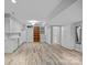 Spacious basement featuring white cabinets, sink, appliances, and built-in shelving at 911 Naples Dr, Davidson, NC 28036