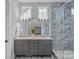 Bathroom boasting a double vanity, marble countertops, and glass enclosed shower at 911 Naples Dr, Davidson, NC 28036