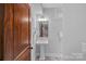 Charming bathroom featuring a pedestal sink, detailed mirror, and a stylish light fixture at 911 Naples Dr, Davidson, NC 28036