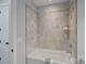Clean bathroom featuring a gray tile shower with a built-in shelf and modern shower fixtures at 911 Naples Dr, Davidson, NC 28036