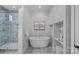 Bathroom featuring a soaking tub, separate shower, and stylish decor at 911 Naples Dr, Davidson, NC 28036