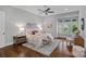 Comfortable bedroom with ceiling fan, hardwood floors, and large windows at 911 Naples Dr, Davidson, NC 28036