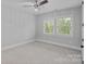 Empty bedroom with ceiling fan, carpet, and double windows at 911 Naples Dr, Davidson, NC 28036