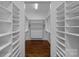 Walk-in closet with custom shelving and hardwood floors at 911 Naples Dr, Davidson, NC 28036