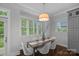 Dining area with a modern chandelier, neutral walls, a window, and contemporary decor at 911 Naples Dr, Davidson, NC 28036