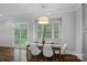 Dining area with modern chandelier, neutral walls, a window, and contemporary decor at 911 Naples Dr, Davidson, NC 28036