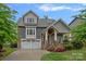 Charming two-story home with a well-manicured lawn, attached two-car garage, covered porch, and neutral color palette at 911 Naples Dr, Davidson, NC 28036