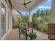 Relaxing front porch with seating, ceiling fan, brick pillars, and black metal railings at 911 Naples Dr, Davidson, NC 28036