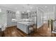 Bright kitchen features gray cabinetry, center island with seating, stainless steel appliances, and hardwood flooring at 911 Naples Dr, Davidson, NC 28036