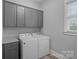 Laundry room featuring washer, dryer, and storage cabinets at 911 Naples Dr, Davidson, NC 28036