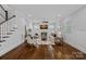 Cozy living room with a fireplace, built-ins, white walls, and hardwood floors creating a comfortable and inviting space at 911 Naples Dr, Davidson, NC 28036