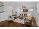 Bright living room featuring a fireplace, modern decor, and hardwood floors at 911 Naples Dr, Davidson, NC 28036