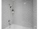 Close-up of a modern shower with white subway tiles, a handheld shower head, and a shelf at 911 Naples Dr, Davidson, NC 28036