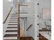 Elegant staircase with wood treads, white risers, shiplap walls, and decorative wood railing leading to the second floor at 911 Naples Dr, Davidson, NC 28036