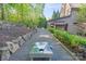 Backyard view of a custom cornhole game area, framed by lush landscaping at 9927 Clarkes View Nw Pl, Concord, NC 28027