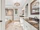 Elegant bathroom with double vanity, soaking tub, walk-in shower, and stylish light fixture at 9927 Clarkes View Nw Pl, Concord, NC 28027