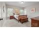Comfortable bedroom with natural light, neutral color palette, and hardwood furniture at 9927 Clarkes View Nw Pl, Concord, NC 28027