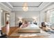 Beautiful bedroom featuring a decorative chandelier, suspended swing chair, and neutral color palette at 9927 Clarkes View Nw Pl, Concord, NC 28027