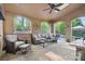 Inviting covered patio with stone floors, comfortable seating, and serene views of the landscaped backyard at 9927 Clarkes View Nw Pl, Concord, NC 28027
