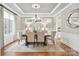 Elegant dining room with tray ceiling, chandelier, and wainscoting at 9927 Clarkes View Nw Pl, Concord, NC 28027