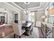 Formal dining room with stylish chandelier, wainscoting, and ample natural light at 9927 Clarkes View Nw Pl, Concord, NC 28027
